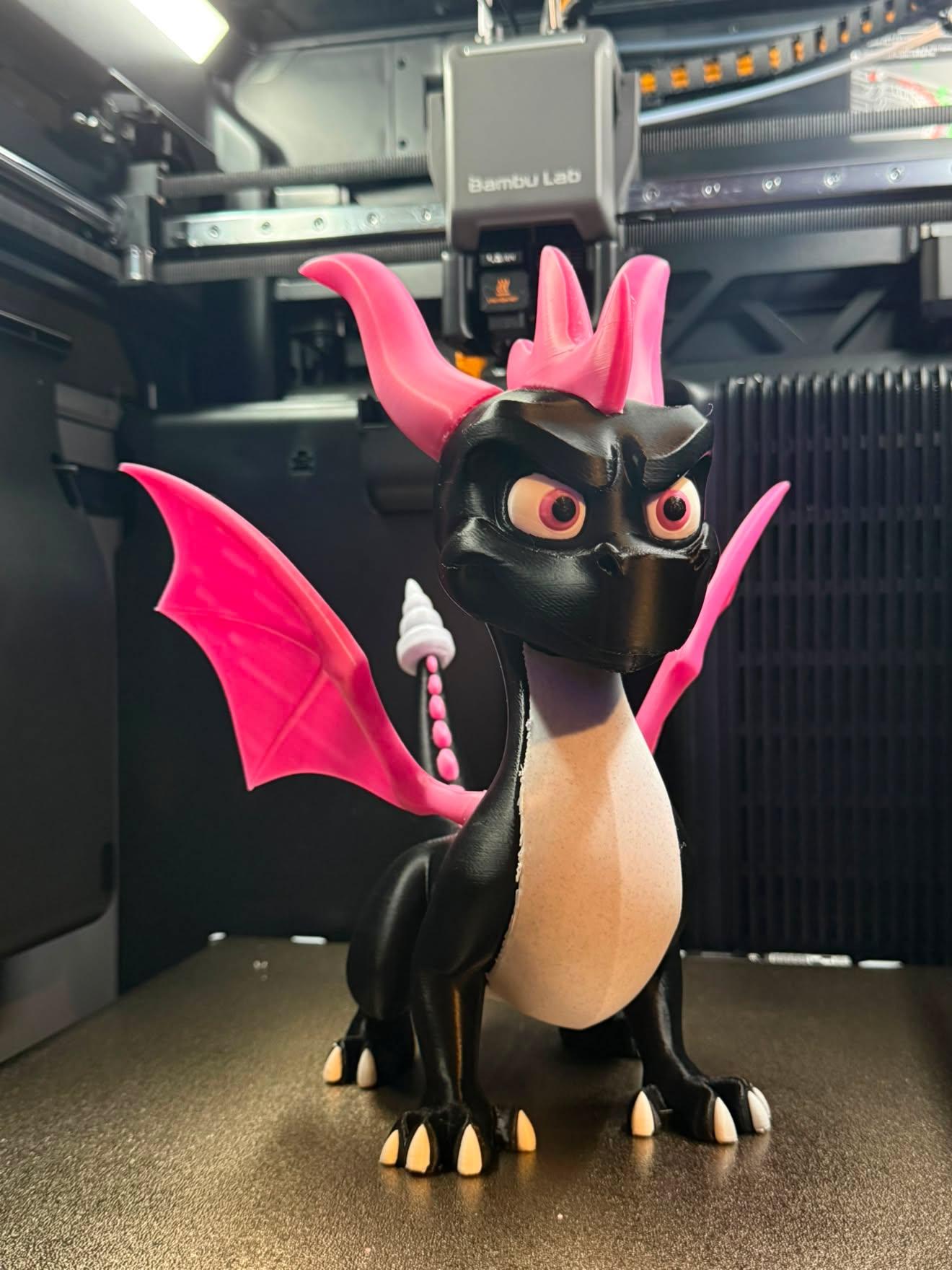 Client photo index 3: three-quarter front view of the dragon on the build plate inside the enclosure, printer mechanism